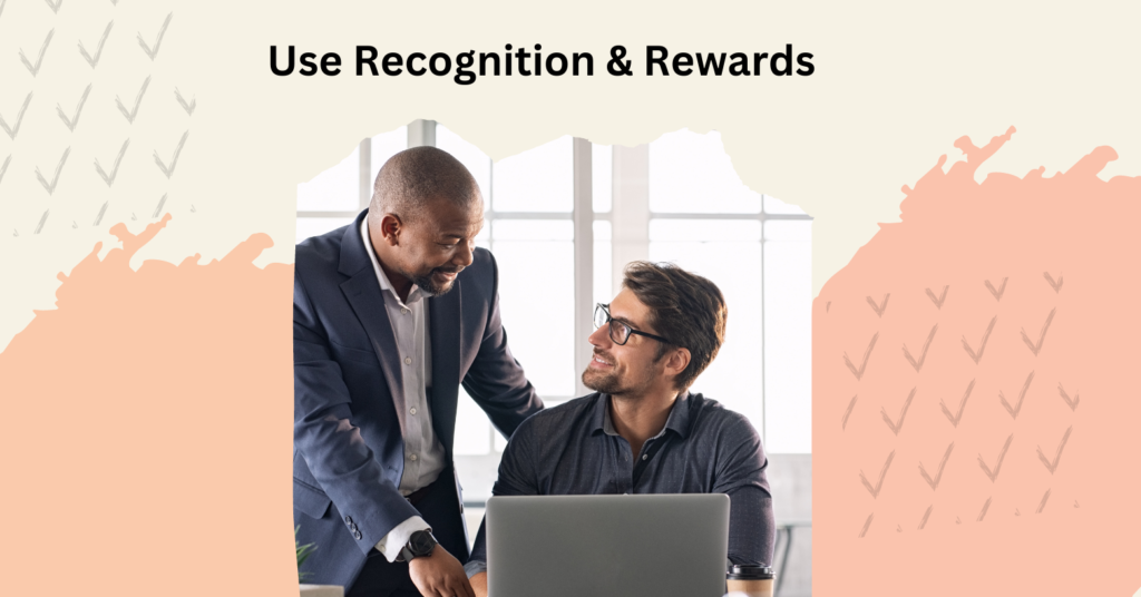 Incentive Program for Employees - two professionals behind laptop looking at each other smiling